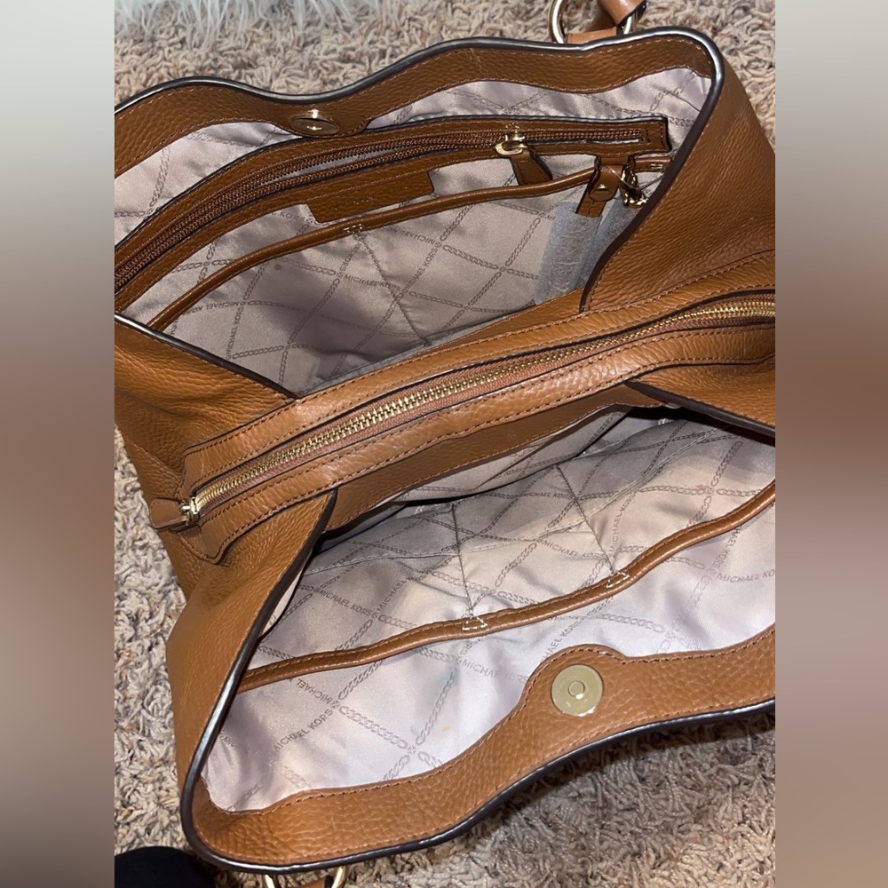 BIGGEST DEAL on Michael Kors bag is a brown leather, brand new.